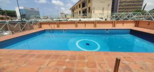 a large blue swimming pool on top of a building at Exquisite 1-bed studio apartment in Ikoyi in Lagos