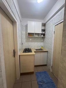 a small kitchen with a sink and a stove at Exquisite 1-bed studio apartment in Ikoyi in Lagos