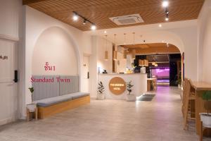 a store lobby with a sign that reads saturated turn at The Modeva Hotel in Kanchanaburi City