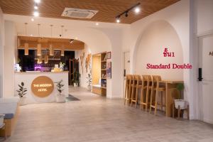 a store with a restaurant with chairs and a counter at The Modeva Hotel in Kanchanaburi City