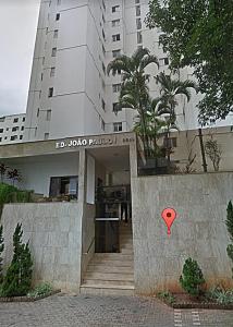 a building with a red sign on a wall at Apartamento 3 quarto Alto Bueno in Goiânia