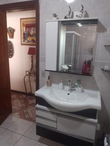 a bathroom with a sink and a mirror at Aconchego da Wal in Campos do Jordão