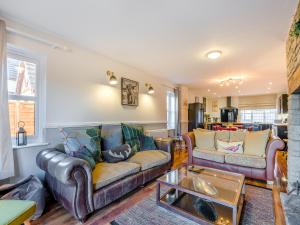 a living room with two couches and a table at Cromwell House - Uk42450 in Winforton