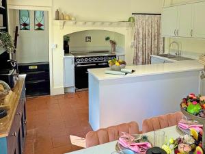 a kitchen with a counter and a stove top oven at Falconer's Lodge in Didlington +22 photos