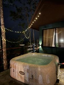 a bathroom with a large bath tub with lights at Windwood Cabin Cerro Azul in Los Altos de Cerro Azul +4 photos