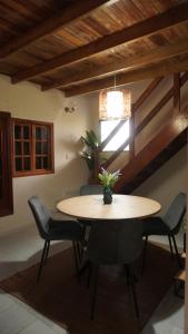 a dining room with a table and chairs and a ceiling at Windwood Cabin Cerro Azul in Los Altos de Cerro Azul
