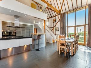 a kitchen and dining room with a table and chairs at Liston Hall Barn in Gosfield