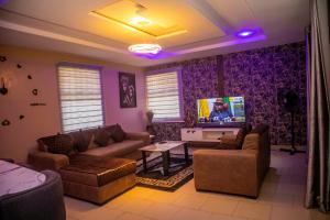 a living room with couches and a flat screen tv at #5 Apartment in Parma