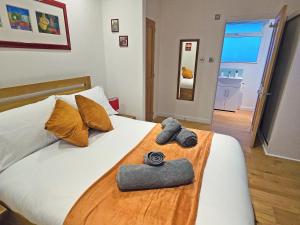 a bedroom with a bed with a camera on it at Dinky Daze - Ukc7071 in Brundall