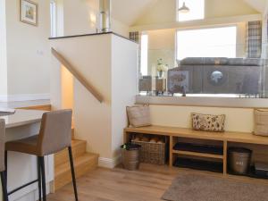 a room with a table and a chair and a window at Falcon Cottage in Linlithgow