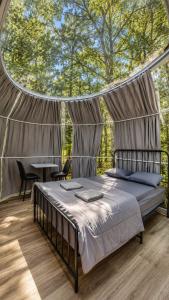a bed in a tent with a table and chairs at Studio Capsule Sand Bay #16 in Dillon