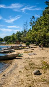 a sandy beach with a boat on the shore at Studio Capsule Sand Bay #16 in Dillon