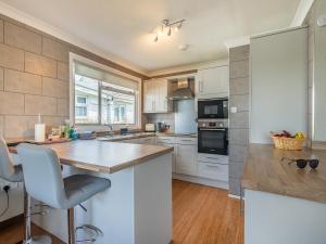 a kitchen with white cabinets and a counter top at River View-Ukc6112 in Brundall