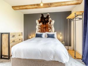 a bedroom with a large white bed with a wooden headboard at The Dairy - Uk44130 in Baystonhill +16 photos