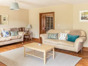 a living room with two couches and a coffee table at Lower Barrowfield Farm in Beaminster