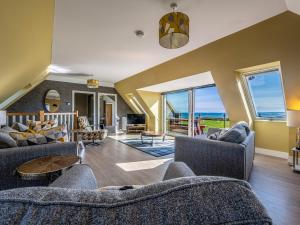 a living room with two couches and a table at Murlin in Collieston