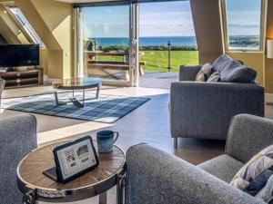 a living room with a laptop on a coffee table at Murlin in Collieston