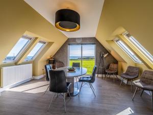a room with skylights and a table and chairs at Murlin in Collieston