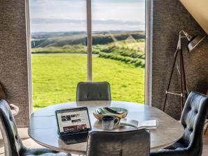 a laptop sitting on a table in front of a window at Murlin in Collieston +32 photos