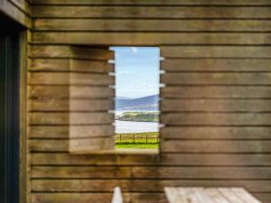 a window in a building with a view of a lake at The Two Byres in Trumpan