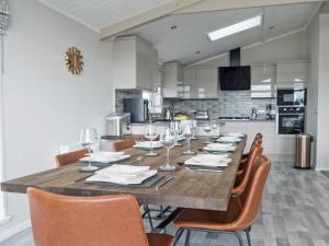 a dining room with a large wooden table and chairs at River Tees Lodge - Ukc4064 in Nunthorpe