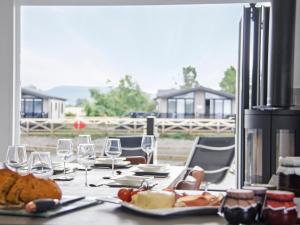 a table with plates of food and wine glasses at River Tees Lodge - Ukc4064 in Nunthorpe +17 photos