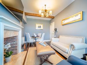a living room with a couch and a fireplace at Lundin Links - Ukc6916 in Turnberry