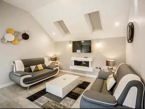 a living room with two couches and a tv at Swallow Cottage-Ukc6983 in Castleside