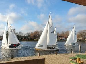 a group of three sailboats on the water at Holly Barn in Ashwellthorpe +15 photos