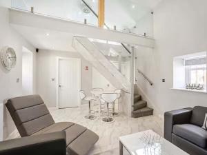 a living room with a couch and chairs and a staircase at Barn Owl Cottage- Ukc6985 in Castleside +3 photos