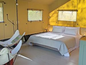 a bedroom with a bed and a chair in it at The Apple Bobber - Ukc7130 in Cratfield