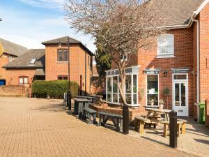 a group of benches in front of a brick building at Star Cottage in Ringwood
