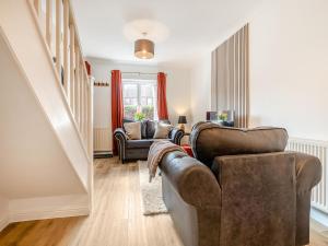 a living room with two chairs and a couch at Star Cottage in Ringwood
