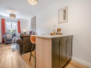 a kitchen and living room with a couch and a table at Star Cottage in Ringwood