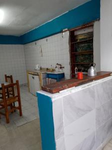 a kitchen with a counter top in a room at El buen descanso in Trelew +4 photos