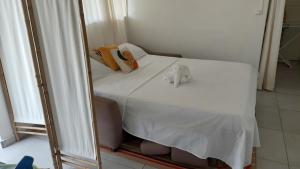 a bedroom with a bed in front of a mirror at Eco-Nature Studio in Petit-Canal