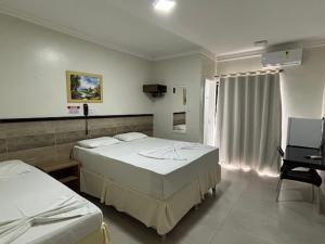 a hospital room with two beds and a desk at Tropical Praia Hotel in Aracaju +24 photos