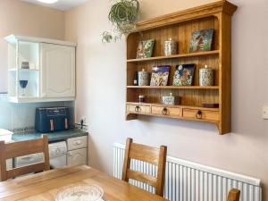 a kitchen with a dining room table and a shelf at Seaspray in Buckie