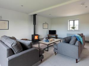 a living room with two couches and a fireplace at The Foundary - Uk36319 in Whitchurch