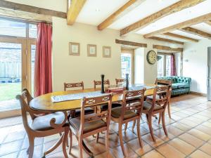 a dining room with a table and chairs at Wern Farm Barn in Cwm-du