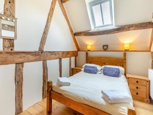 a bedroom with a bed and a window at Wern Farm Barn in Cwm-du +15 photos