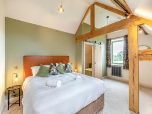 a bedroom with a large bed and a window at The Stables - Uk44139 in Baystonhill +16 photos