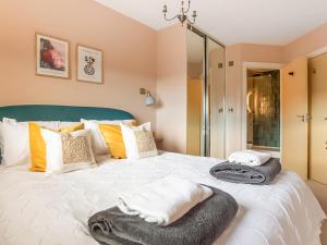 a bedroom with a bed with towels on it at The Wharf in Warwick