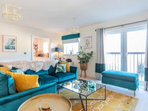 a living room with a blue couch and a table at The Wharf in Warwick
