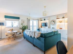 a living room with a blue couch and a table at The Wharf in Warwick +10 photos