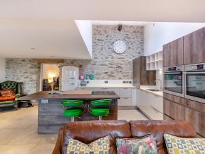 a kitchen with a couch and a counter in a room at Ty Eufron in St. Davids