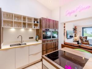 a kitchen with white cabinets and a counter top at Ty Eufron in St. Davids +17 photos
