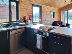 a kitchen with black cabinets and a counter top at Nature's Nook in Brundall