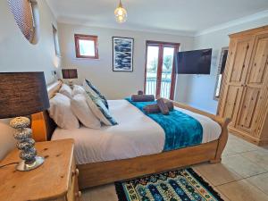 a bedroom with a bed and a desk and a television at Flag House - Ukc7074 in Brundall