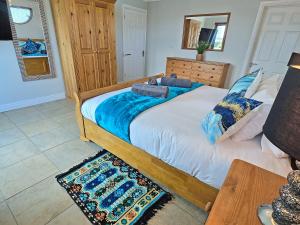 a bedroom with a large bed and a table at Flag House - Ukc7074 in Brundall